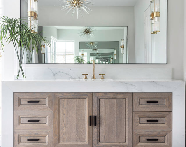 Carrara marble kitchen with luxury range and custom pot holder detail in Houston, TX